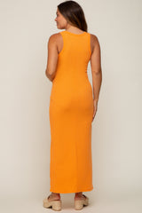 woman wearing an orange maternity maxi dress with a fitted silhouette, showing a smooth back view