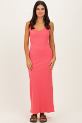 woman wearing a bright pink ribbed maxi dress with a scoop neckline and spaghetti straps