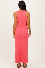 woman wearing a fitted coral sleeveless maxi dress, view from the back