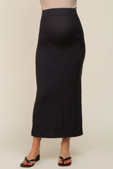 pregnant woman wearing a black ribbed maternity maxi skirt with a high waistband