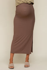 woman wearing a brown ribbed maternity skirt with a side slit and a visible baby bump