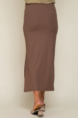 woman wearing a brown ribbed maternity skirt with a side slit, view from the back