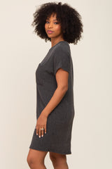 woman wearing a black striped short sleeve dress with a relaxed fit and pocket detail