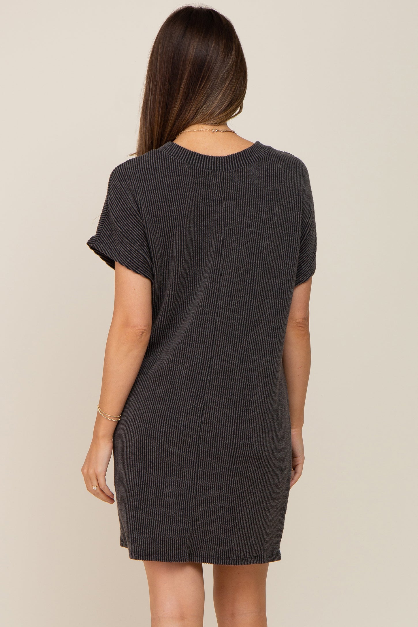 woman wearing a dark gray ribbed maternity t-shirt dress, shown from the back