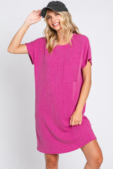 woman wearing a magenta ribbed t-shirt dress with a front pocket and a grey baseball cap