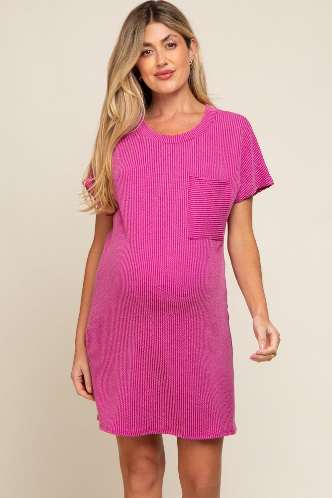 woman wearing a pink ribbed maternity dress with a pocket and a visible baby bump