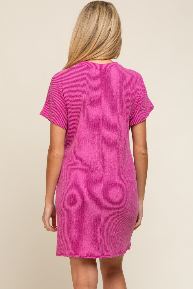woman wearing a pink short sleeve maternity dress with a relaxed fit and ribbed texture