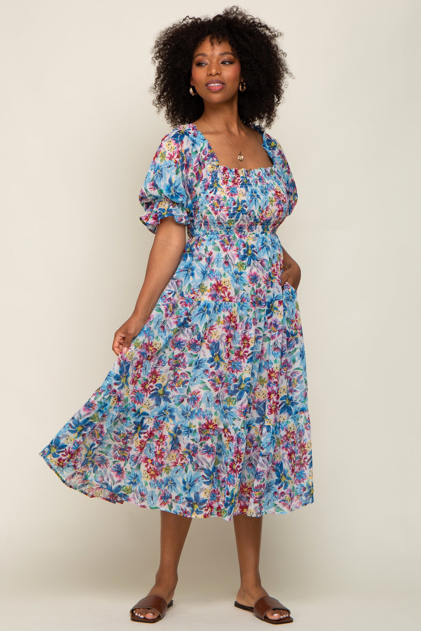 woman wearing a floral long sleeve maxi dress with a square neckline and puff sleeves