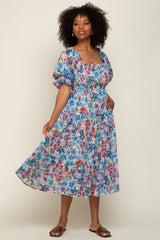 woman wearing a floral long sleeve maxi dress with a square neckline and puff sleeves