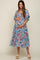 woman wearing a blue floral maxi maternity dress and holding her baby bump