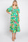 woman wearing a green floral mid-length dress with puff sleeves and a smocked bodice