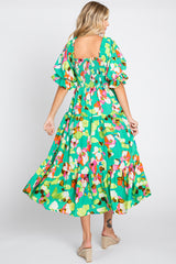 woman wearing a vibrant floral maxi dress with puff sleeves and a smocked back, seen from the back, standing in a twirl