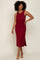 woman with curly hair wearing a sleeveless burgundy ribbed midi dress and tan slide sandals