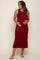 woman wearing a burgundy sleeveless maternity dress and cradling her baby bump