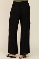 back view of woman wearing black wide leg cargo pants with elastic waistband and frayed hem