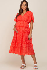 pregnant woman in a red leopard print tiered maternity midi dress with flutter sleeves and white sandals