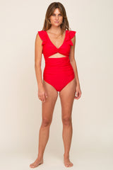 woman wearing a red cut-out one-piece swimsuit with ruffled sleeves and a deep v-neckline