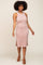 woman with afro hair wearing a mauve ribbed sleeveless midi dress and brown sandals