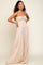 woman wearing a light beige strapless maxi dress with smocked bodice and flowing skirt, posing confidently