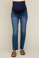 woman wearing dark blue maternity jeans with a supportive belly panel and a fitted style