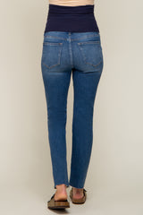 woman wearing blue maternity skinny jeans with a dark waistband, viewed from the back