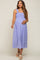 Pregnant woman wearing a light purple smocked maternity midi dress with ruffle straps and woven platform sandals