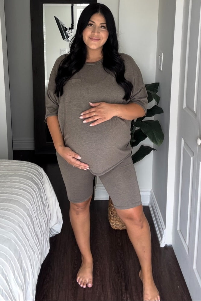 Pregnant woman wearing a brown maternity lounge set with oversized t-shirt and biker shorts