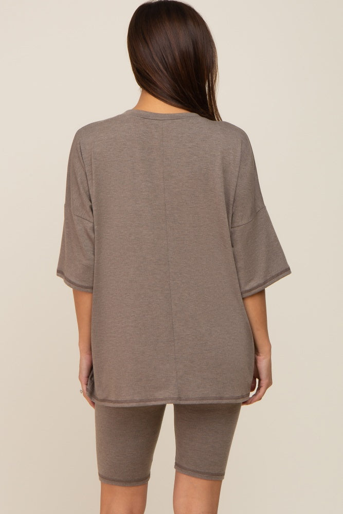 woman wearing a brown maternity loungewear set with a loose t-shirt and matching shorts