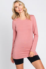 woman wearing a long sleeve dusty rose crew neck tunic top and black biker shorts