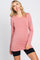 woman wearing a long sleeve dusty rose crew neck tunic top and black biker shorts