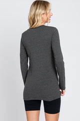 woman wearing a dark gray long sleeve top from the back with a relaxed fit and side slits