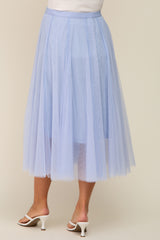 woman wearing a light blue maternity tulle midi skirt, showcasing a flowy design and layered texture from the back