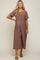 pregnant woman wearing a mauve lace-up short sleeve maternity jumpsuit with wide legs