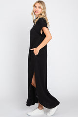 woman wearing a black sleeveless maxi dress with side slits and pockets, styled with white sneakers