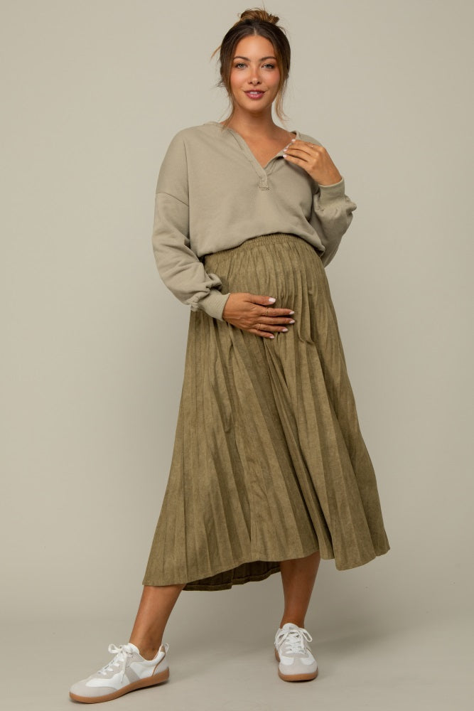 pregnant woman wearing olive green pleated maternity midi skirt and tan long sleeve henley top