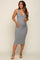 Pregnant woman modeling a grey ribbed sleeveless midi maternity dress with a v-neckline and tan heels