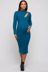 woman wearing a teal ribbed long sleeve maternity dress with an angled cutout and showing her baby bump.