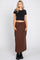 woman wearing a black crop top and brown maxi cargo skirt with side pockets and black boots