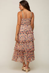 woman wearing a floral tiered midi dress with smocked back and spaghetti straps