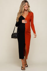 pregnant woman in a two-tone black and orange ribbed maternity midi dress with buttons and a black handbag