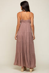 back view of woman wearing mauve floral tiered maxi dress with spaghetti straps and platform sandals