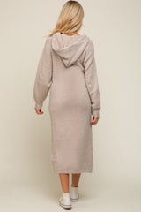 woman wearing a beige maternity long sleeve hoodie dress, showing a slim fit and knee-length design from the back