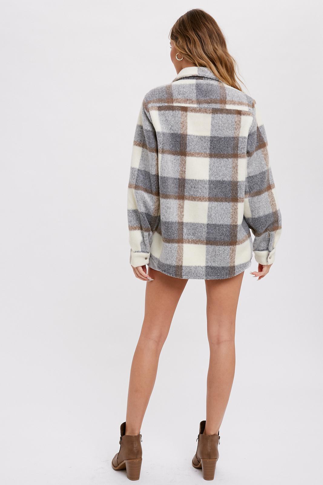 woman wearing a gray and cream plaid oversized shacket with long sleeves and a relaxed fit, viewed from the back