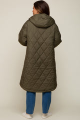 woman wearing a long olive green quilted maternity coat with a hood, shown from the back
