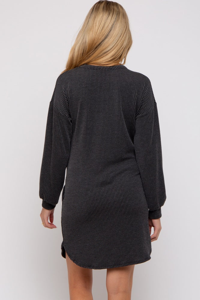 woman wearing a black and gray striped maternity sweater dress, showing the back view with long sleeves