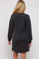 woman wearing a black and gray striped maternity sweater dress, showing the back view with long sleeves