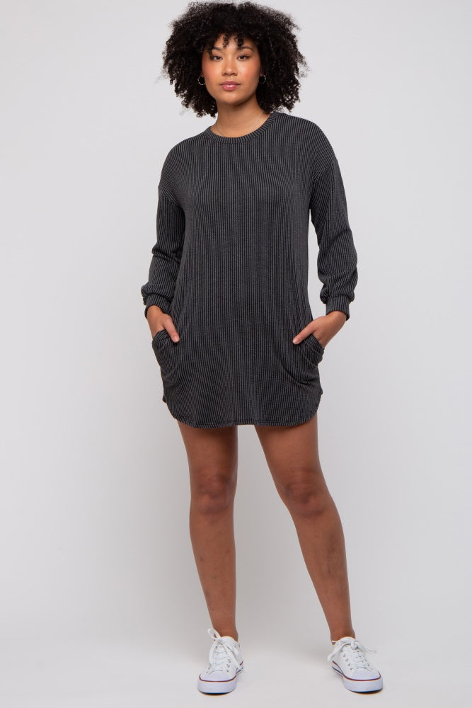 woman wearing a black ribbed long sleeve dress with pockets
