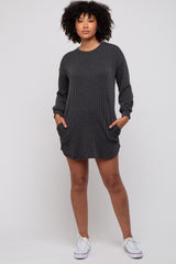 woman wearing a black ribbed long sleeve dress with pockets