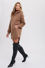 Woman wearing a brown sherpa fleece hoodie dress and black over-the-knee stiletto boots