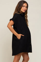 pregnant woman wearing a black short sleeve button down maternity shirt dress with pockets